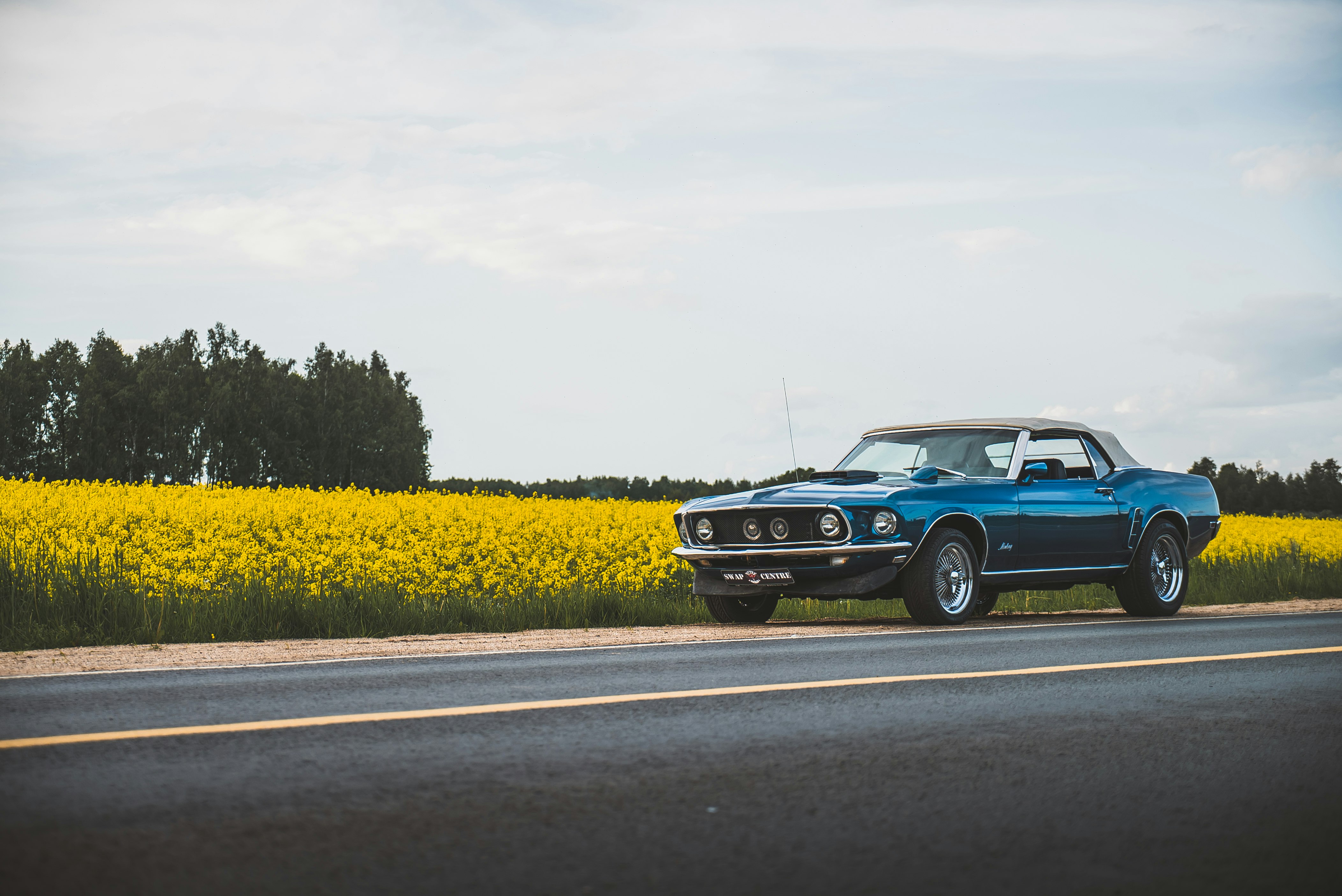 blue classic car on road during daytime